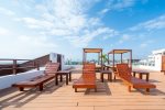 The Casa del Mar community rooftop with pool, ocean view, beds, and lounge chairs